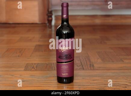 bottle of Colome brand Argentinian Malbec red wine from high altitude growth on a wood background Stock Photo