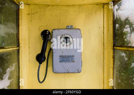 Vintage callbox in winter city park, snow landscape Stock Photo