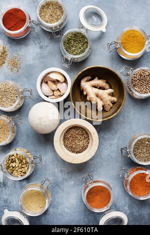 Spice jars with fresh ginger and garlic Stock Photo