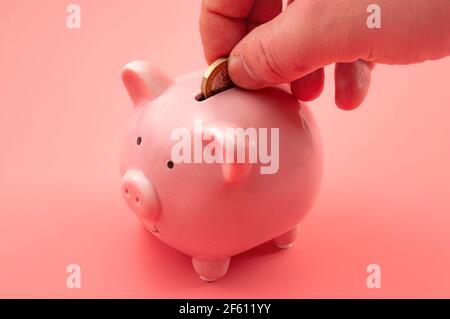 Prosperity in personal finances, money growth, modern economics and saving capital conceptual theme with hand investing for retirement by putting a co Stock Photo