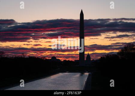 The sunrise is seen over the National Mall and U.S. Capitol Building, in Washington, D.C., at dawn on Monday, March 29, 2021, amid the coronavirus pandemic. Last week President Biden committed to a new goal of 200 million vaccine doses in his first hundred days in office, as American public health experts warn a new wave of COVID-19 cases may be starting as infection numbers rise in many areas of the country (Graeme Sloan/Sipa USA) Stock Photo
