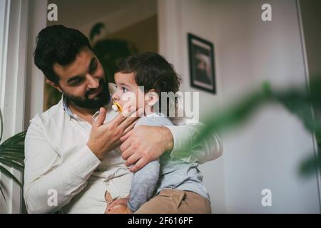 Father embracing son at home Stock Photo
