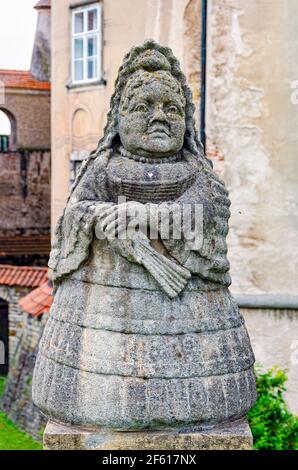 Statue of a female dwarf (carved by workshop of baroque sculptor Matthias Bernard Braun) in front of the castle Nove Mesto nad Metuji, Czech Republic Stock Photo
