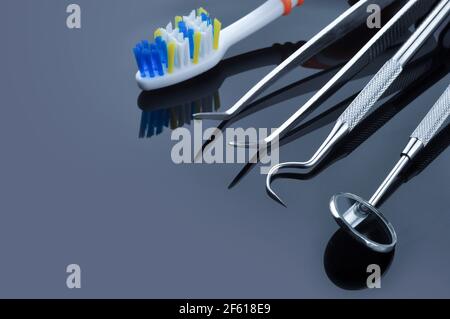 Dental care. Dental tools on a gray background. Dental treatment. Stock Photo