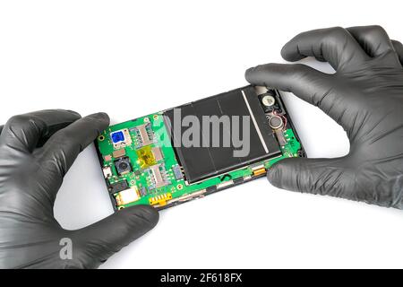 Master repairs the smartphone in the service center close-up Stock Photo