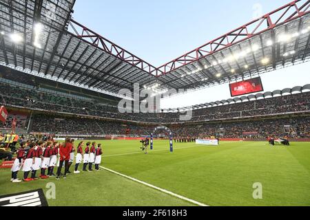 Kids wearing AC Milan's uniforms enter the San Siro football stadium pitch, in Milan, Italy. Stock Photo