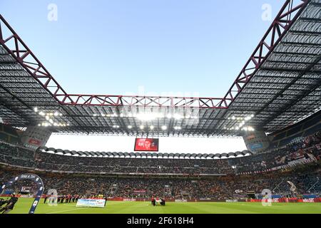 Football fans seat watching a football match at the san siro stadium, during the italian Serie A, in Milan, Italy. Stock Photo