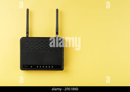 Router wireless LAN technology with devices based on IEEE 802.11 standards on a yellow background free space top view. Isolate Stock Photo