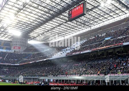 Football fans seat watching a football match at the san siro stadium, during the italian Serie A, in Milan, Italy. Stock Photo