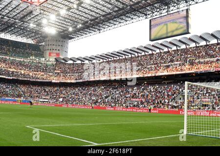 Football fans seat watching a football match at the san siro stadium, during the italian Serie A, in Milan, Italy. Stock Photo