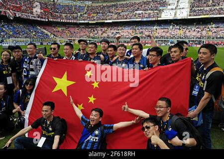 Chinese Inter Milan's football fans with China's flag at the san siro football stadium, in Milan. Italy. Stock Photo