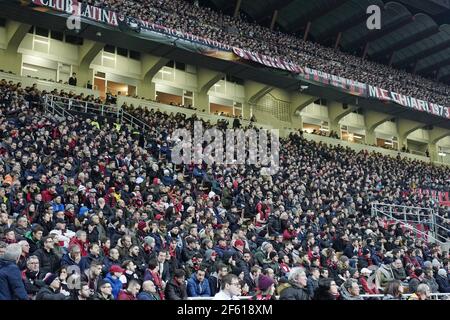 Football fans seat watching a football match at the san siro stadium, during the italian Serie A, in Milan, Italy. Stock Photo