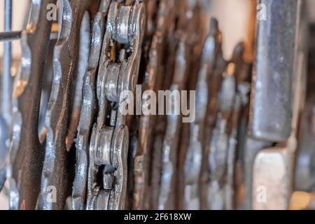 Macro close up chain with gears smeared with oil and dirt Stock Photo