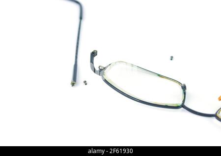 Broken Eyeglasses isolated on white background. Eyeglasses repair concept. Stock Photo