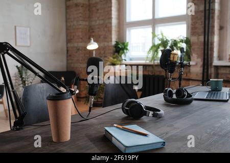 Image of modern recording studio with table with laptop and microphone on it Stock Photo