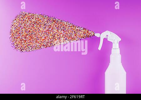 Spray splashes with colored balls on a pink background. Free space concept Stock Photo