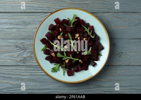 Bowl with fresh beet salad on wooden table Stock Photo