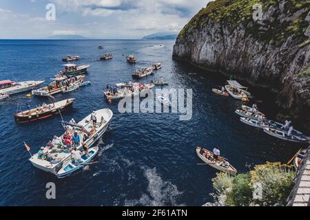 Capri, Italy - May 25, 2014: Tourists waiting on the boat outside the entrance to blue Grotto a sea cave on the coast of the island of Capri in southe Stock Photo
