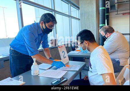 Frisco TX, USA - March 26, 2021: Close up view of hospital assistant helping people registering the covid-19 vaccine Stock Photo