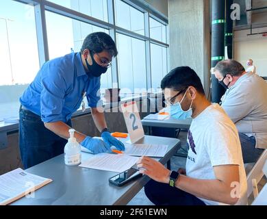 Frisco TX, USA - March 26, 2021: Close up view of hospital assistant helping people registering the covid-19 vaccine Stock Photo