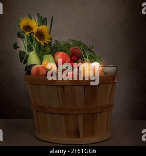 Organic vegetables basket full of fresh vegetables, fruit and eggs from free-range chickens. Stock Photo