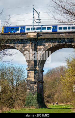 A Northern Rail train crossing the Sankey viaduct at Earlestown over the Sankey Valley. Stock Photo