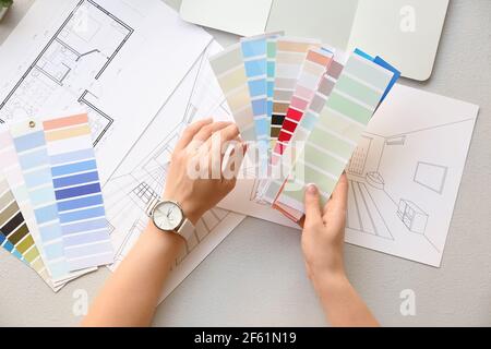 Female interior designer with color palettes in office Stock Photo