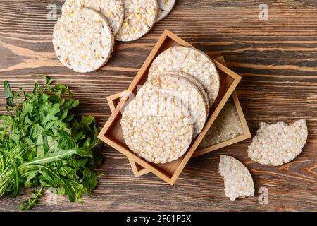 Box with rice crackers on wooden background Stock Photo