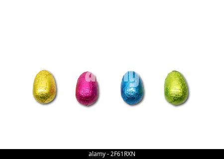 Four wrapped chocolate Easter eggs on white. Stock Photo