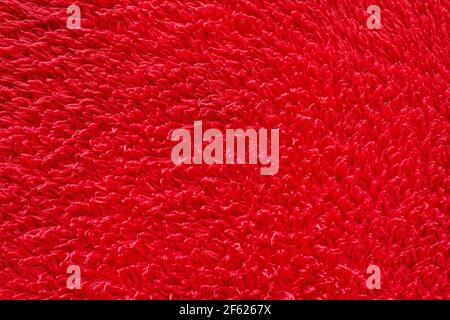 Red color fur background, soft wool material texture. Stock Photo