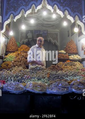 Marrakesh, Morocco - March 29, 2013: Seller of traditional Moroccan pastries in the souk of Marrakech Stock Photo