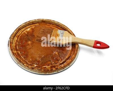 used brush on bucket lid isolated on white background Stock Photo