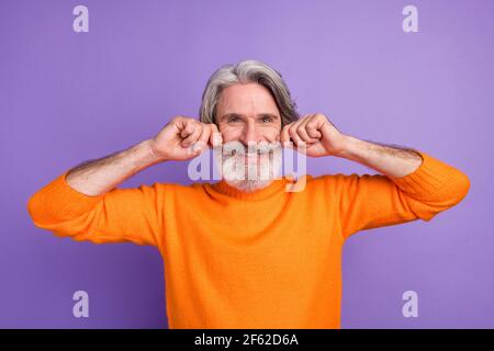 Photo of aged man happy positive smile hands touch mustache funky cool isolated over violet color background Stock Photo