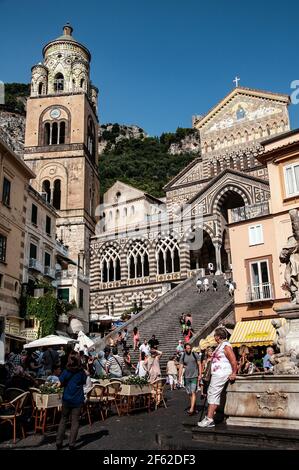 Tourists sitting on steps of 9th century Roman Catholic Amalfi Cathedral, Pizza del Duomo, Amalfi, Italy Stock Photo