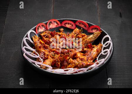 Kerala style Prawns roast or chemmeen varattiyathu  made using red kashmiri chilli flakes and coconut slices as main ingrediants and garnished with on Stock Photo