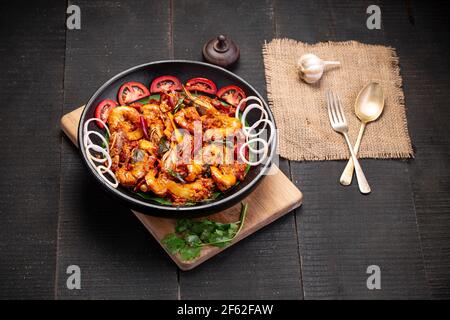 Kerala style Prawns roast or chemmeen varattiyathu  made using red kashmiri chilli flakes and coconut slices as main ingrediants and garnished with on Stock Photo