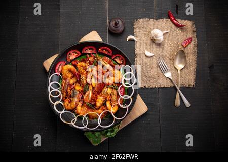 Kerala style Prawns roast or chemmeen varattiyathu  made using red kashmiri chilli flakes and coconut slices as main ingrediants and garnished with on Stock Photo