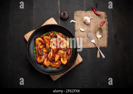 Kerala style Prawns roast or chemmeen varattiyathu  made using red kashmiri chilli flakes and coconut slices as main ingrediants and garnished with on Stock Photo