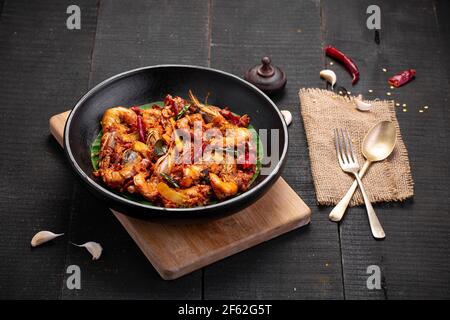 Kerala style Prawns roast or chemmeen varattiyathu  made using red kashmiri chilli flakes and coconut slices as main ingrediants and garnished with on Stock Photo