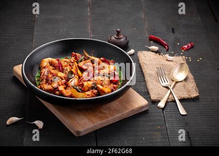 Kerala style Prawns roast or chemmeen varattiyathu  made using red kashmiri chilli flakes and coconut slices as main ingrediants and garnished with on Stock Photo