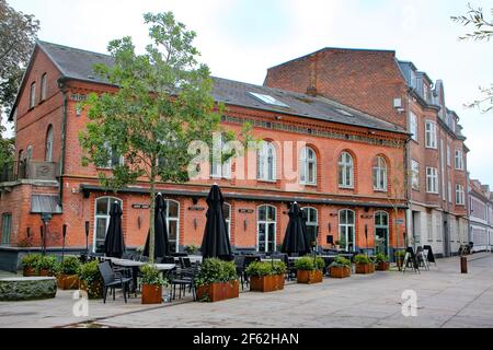 Historic buildings including shops, bars and restaurants surrounding Toldbod Plads square which is located in the heart of Aalborg near the waterfront Stock Photo