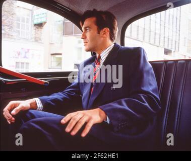Business man riding in London cab, City of London, London, England, United Kingdom Stock Photo