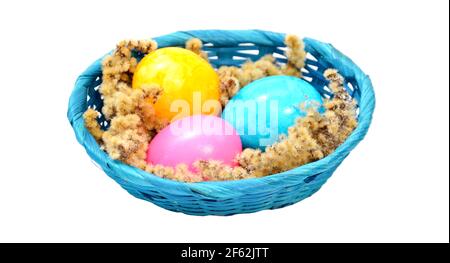 painted easter eggs in a basket on a white background Stock Photo