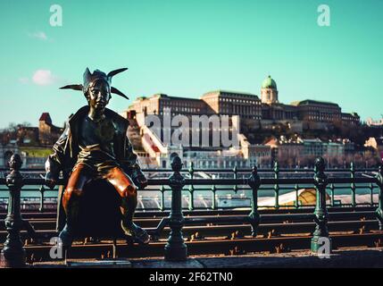 Capture of the Little Princess statue, in Budapest, with Budapest's Palace in the background Stock Photo