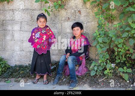 Tzotzil children, boy and girl with traditional clothes posing in the town San Lorenzo Zinacantán, Chiapas, southern Mexico Stock Photo