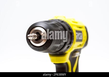 Ryobi 3/8" cordless electric drill showing a closeup of 3-jawed chuck with a Phillips screw driver bit inserted. Stock Photo