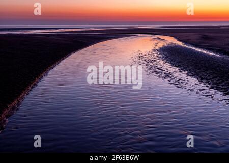Tidal pools on Talacre beach at dawn, North Wales coast Stock Photo
