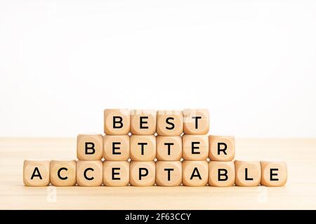 Best, better, acceptable words on wooden blocks on table. Rating concept. White background. Copy space Stock Photo