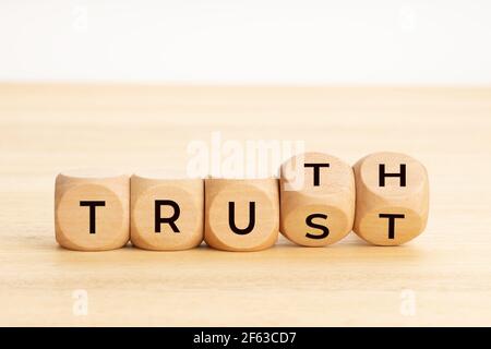 Truth or trust concept. Text on wooden blocks. White background. Copy space Stock Photo