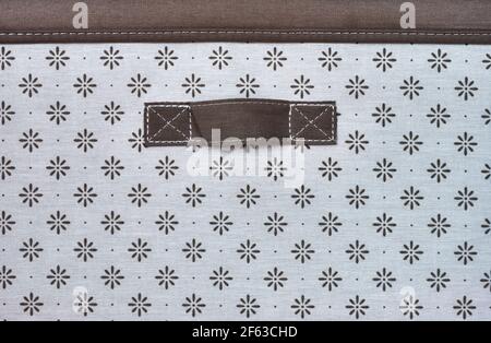 detail of a brown fabric handle of a box to keep clothes in. Stock Photo